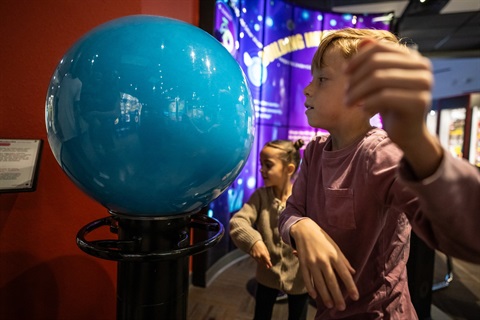 Bradbury Science Museum 2024 Fall Boy spinning large globe