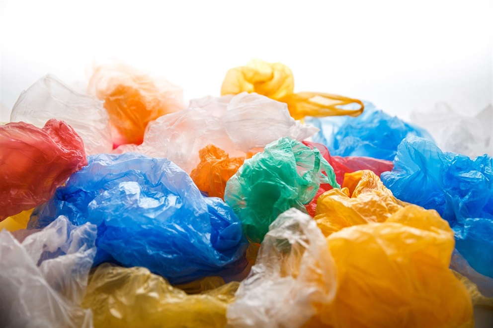 Photograph of colorful single-use plastic bags crumpled and piled together