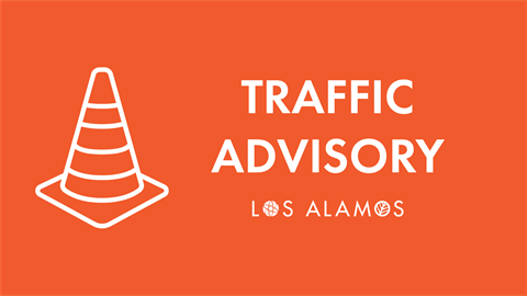 Orange banner with white traffic cone and text Traffic Advisory Los Alamos