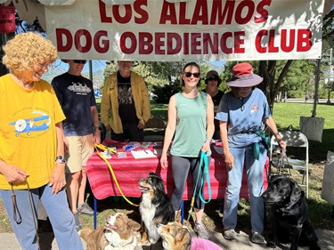 Photograph of the Los Alamos Dog Obedience Club booth and their pooches