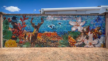 Photograph of the glass tiles on the wall of the Justice Center awaiting grout.