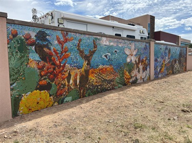 A large mosaic wall depicting various local flora and fauna.