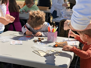 A photo of a boy decorating his solar car at ScienceFest