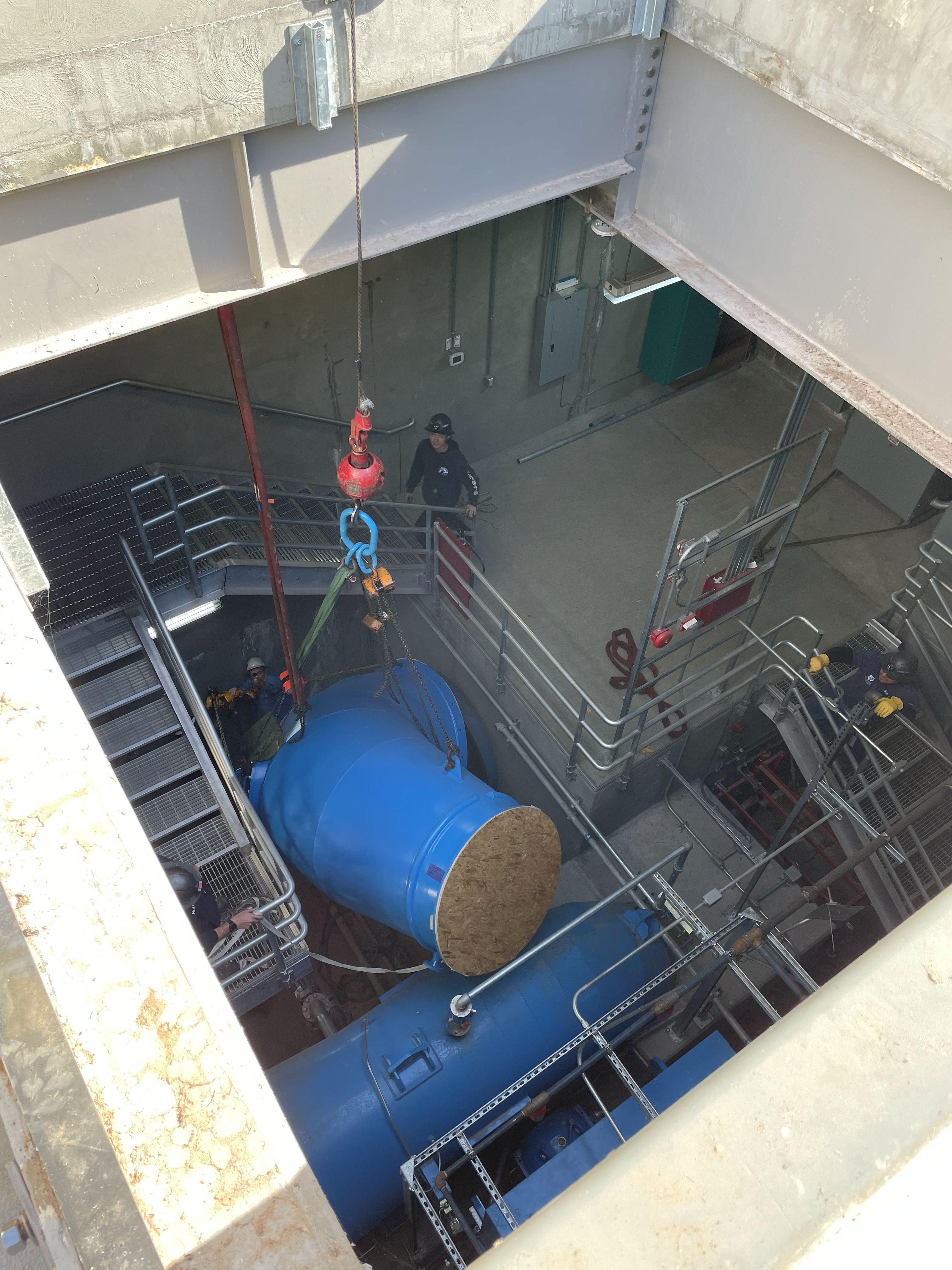 Lowering elbow into lower level of dam