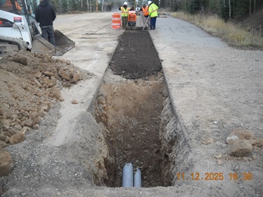 backfilling trench with dirt and asphalt