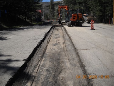 equipment scraping pavement layer off
