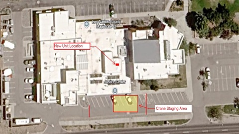 Satellite image of a large building with a yellow box showing the location where a large crane will be operating.