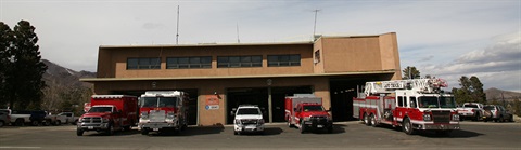 Image depicting LAFD fire station no. 1 with engines and trucks visible pulled out of the bay doors