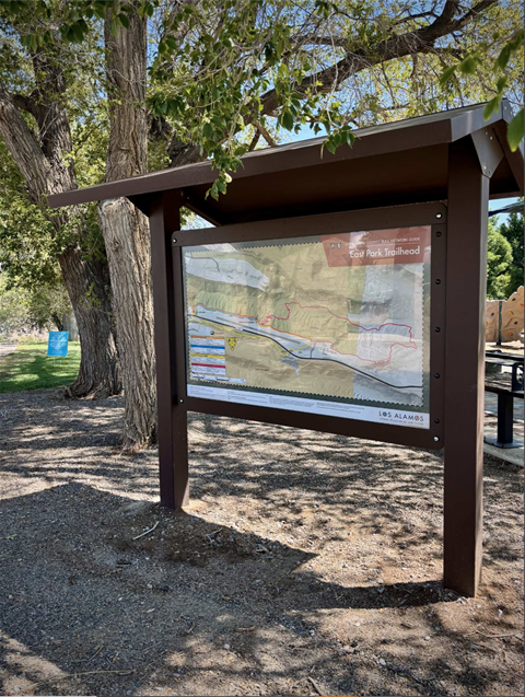 East Park Trailhead entrance with trail sign and surrounding trees in Los Alamos County