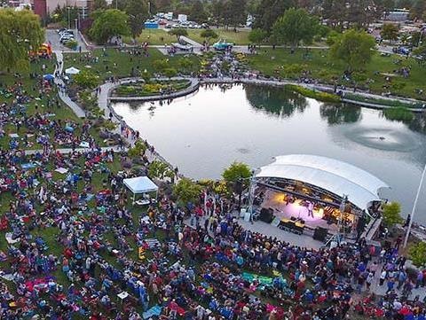 Photograph of a large crowd in front of the Ashley Pond stage during the summer concert.